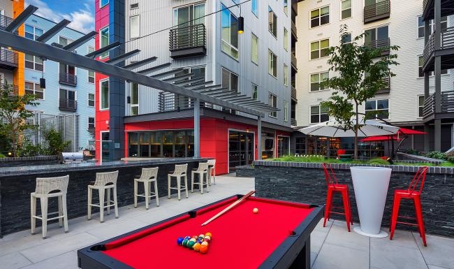 a pool table and chairs outside