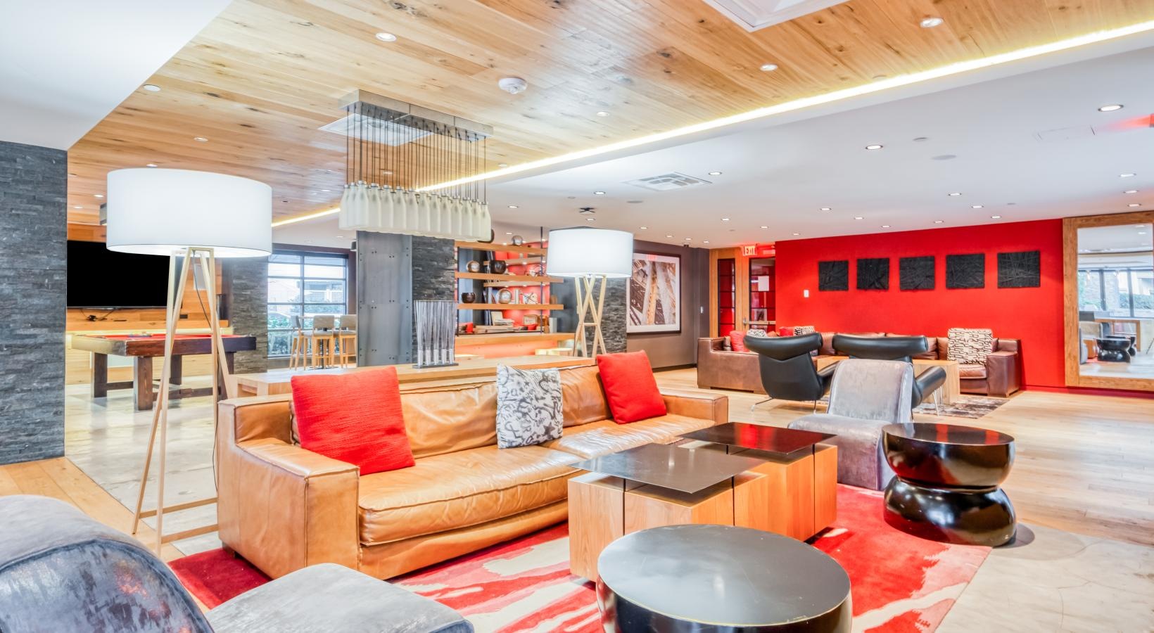 a spacious lounge with a large red wall
